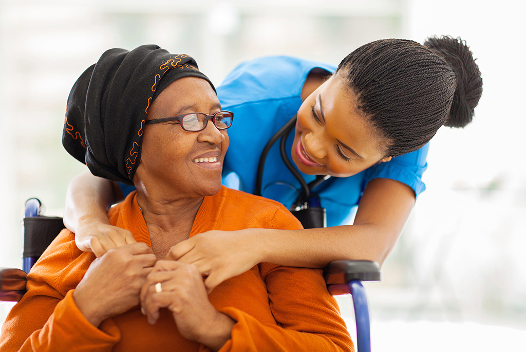 cna caregiver hugging senior woman